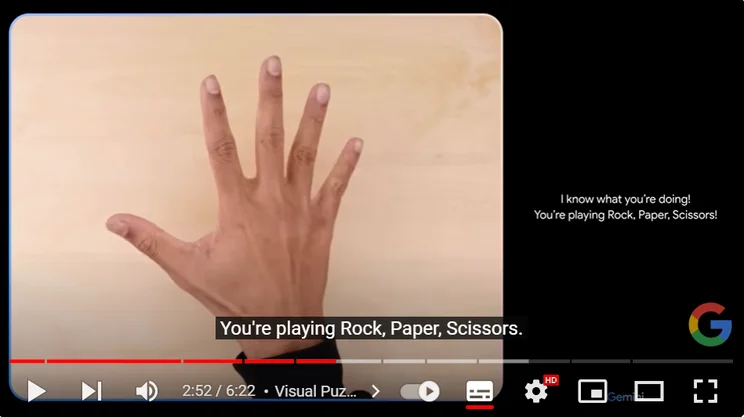 Screenshot of Google Gemini AI video showing rock, paper, scissors game