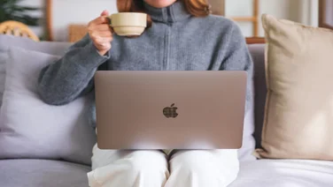 Person working from home with a Mac laptop