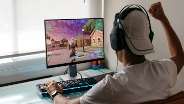 Young person plays popular Epic Games title Fortnite on PC computer