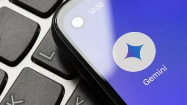 Google's new Gemini app logo on a smartphone screen resting on keyboard