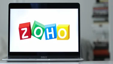 Zoho software logo open on MacBook Air screen