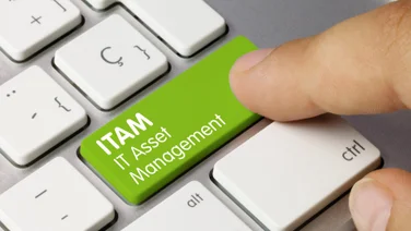 Words IT Asset Management on a green button on a keyboard