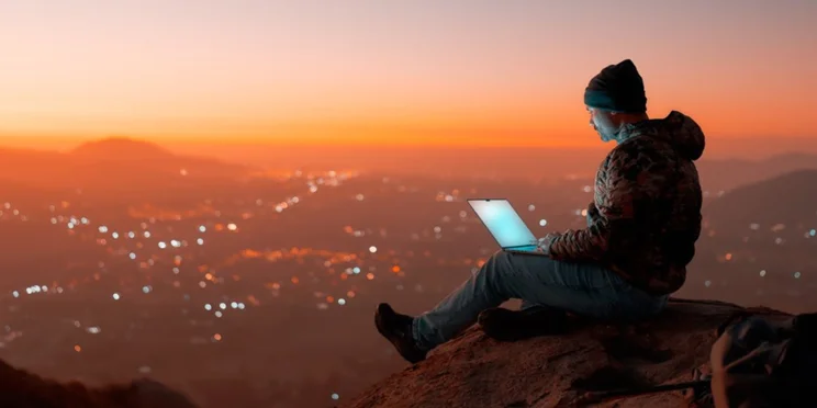 Digital nomad sitting on a rock