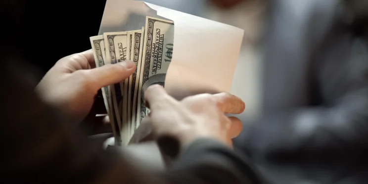 Dollars in envelope illustrating concept of asset misappropriation