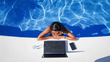 Woman working by the pool