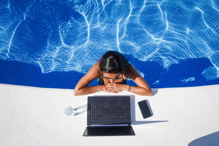 Woman working by the pool