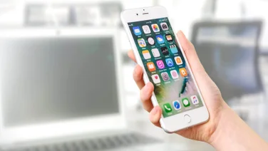 An android phone, held in hand.