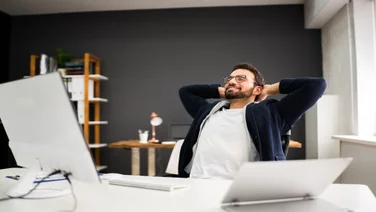 Man looking relaxed at his desk