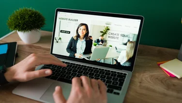 Professional using a website builder at their desk