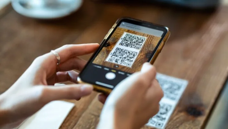 Customer scanning QR code to order food at the table