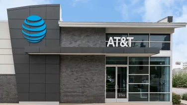 AT&T corporate office with logo on a partly cloudy day