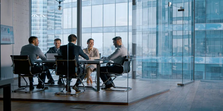 People sitting in a meeting room in an office.