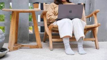 Lady working from home with a macbook