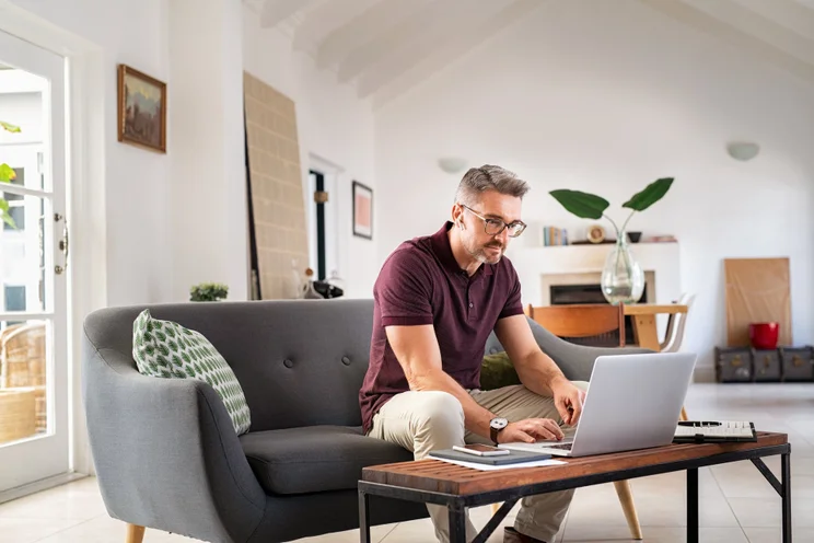 Man working remotely on his sofa