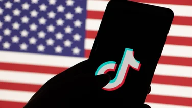 TikTok logo in front of the US flag