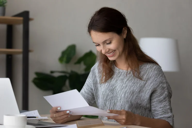 Woman reading a grant approval letter