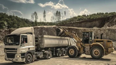 A truck next to construction equipment