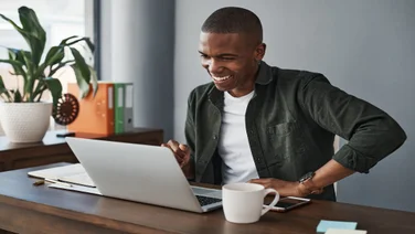 man smiling looking at laptop