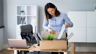 Women is packing up her stuff after quitting