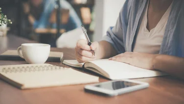 Learning online and writing in a notebook