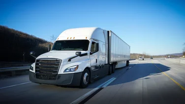 White truck driving on a highway