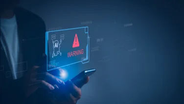 A mobile phone showing a projection of AI scam warning.