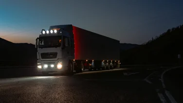 A truck drives at night