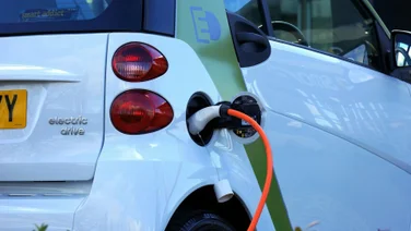 An electric vehicle charging at a station.