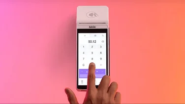 A person types in an amount to a Helcim card reader
