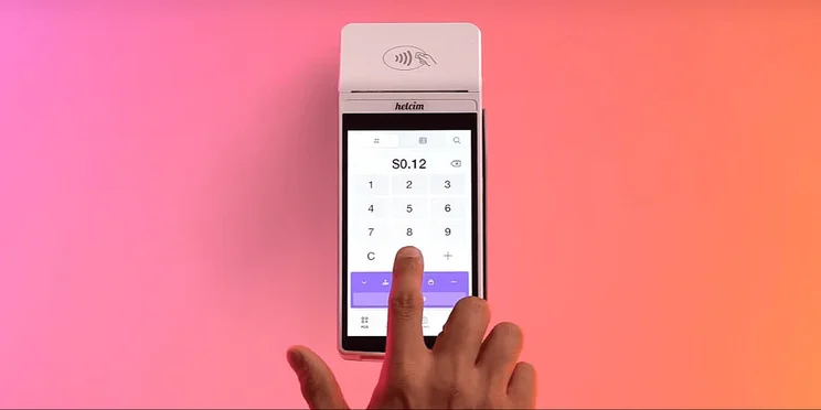 A person types in an amount to a Helcim card reader
