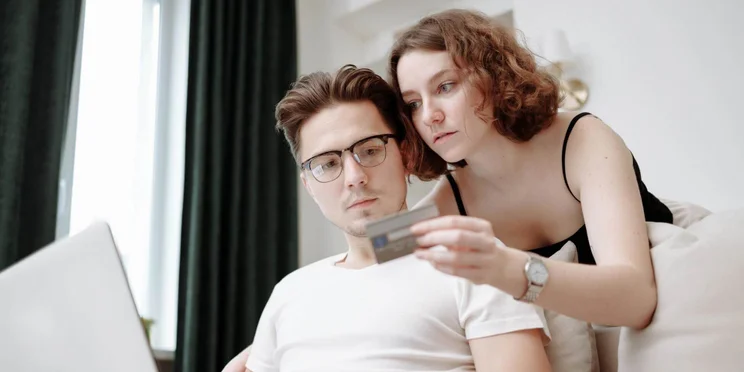 A young couple-spending with a credit card