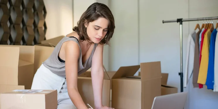 A woman at home places online package returns