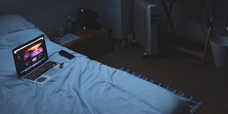 A laptop on a bed for remote work