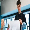 A cafe worker uses a POS system. Source: Tech.co