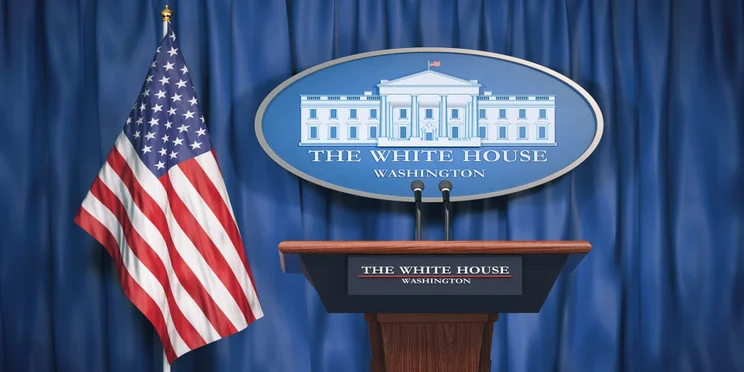 White House lectern in front of US flag