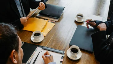 Coffee cups in an office meeting
