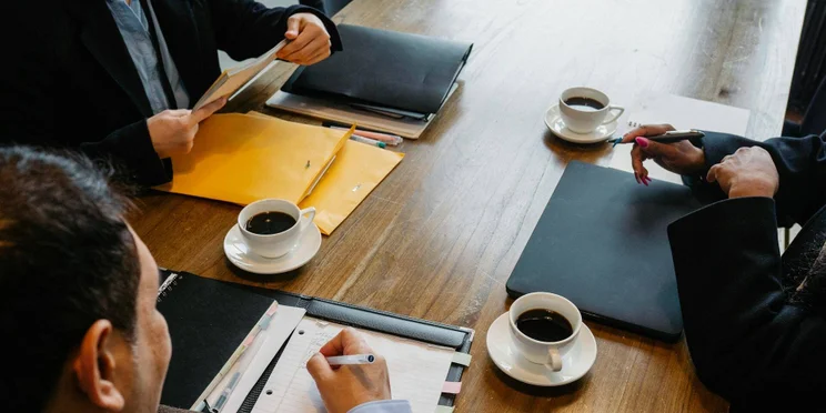Coffee cups in an office meeting