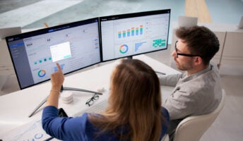 Office workers using expense management software