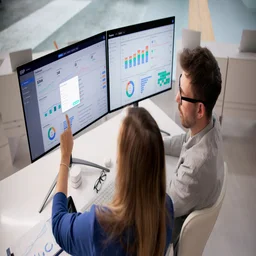 Office workers using expense management software