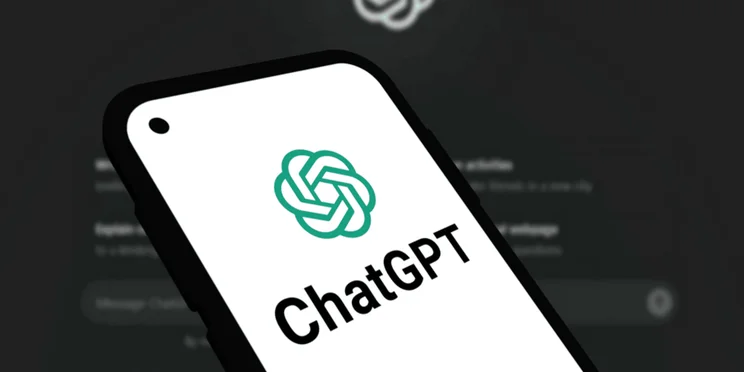chatgpt logo on a phone screen, with the desktop version in the background.