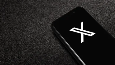 Phone with X logo on black background