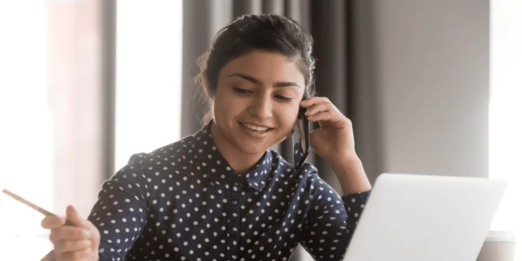 A woman takes a phone interview call.