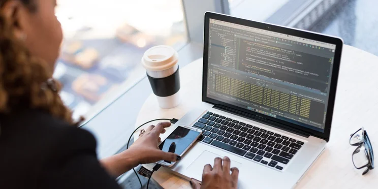 Someone coding on a laptop