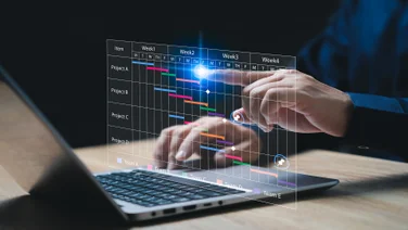 Person at laptop with graphic of chart in front of them