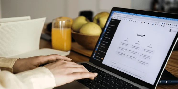 A person uses ChatGPT on their laptop