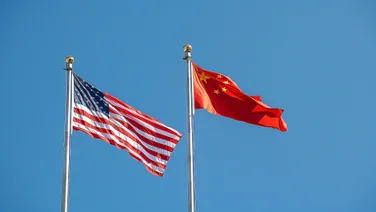 US and Chinese flags blowing in the wind