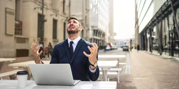 Man on laptop yells