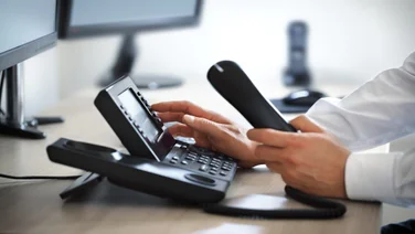 Office worker using desk phone
