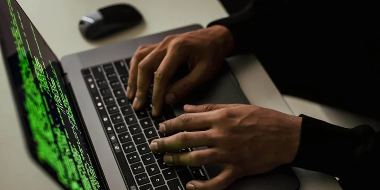 Typing code on a laptop