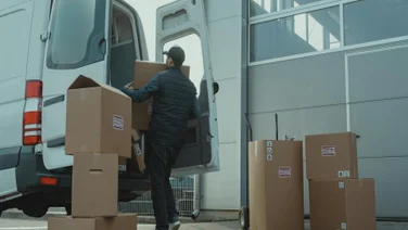 Packages are unloaded from a light-duty truck